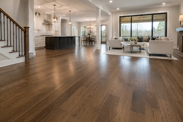 Rich hardwood flooring flowing through an open-concept living room and kitchen